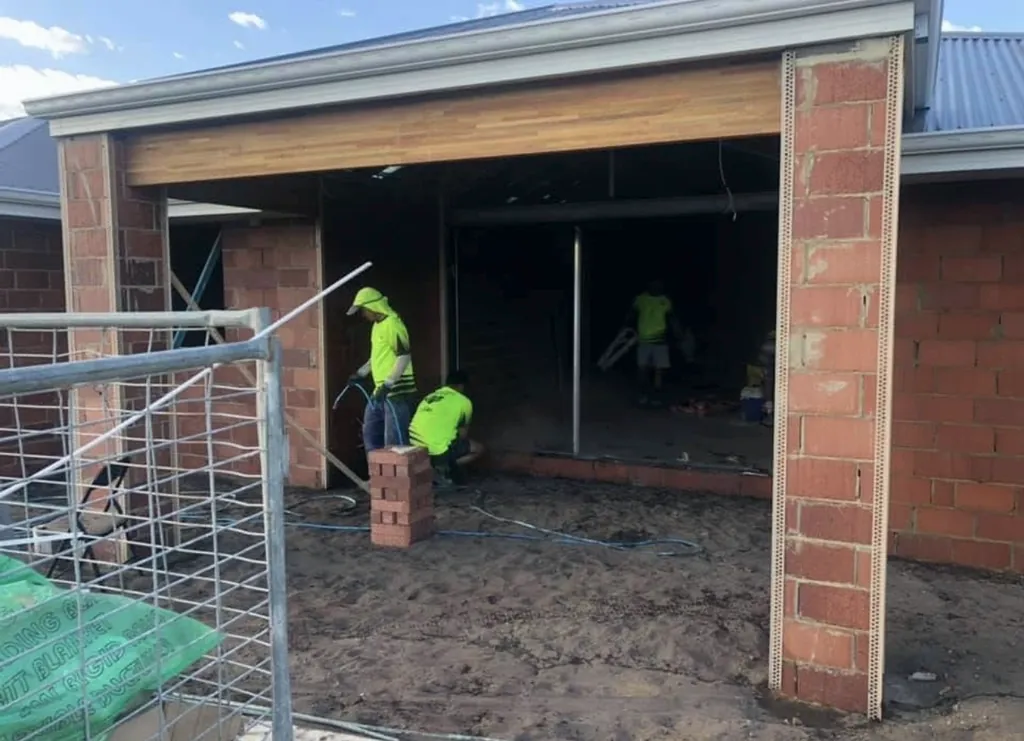 Corner beads fixed to brick piers before rendering