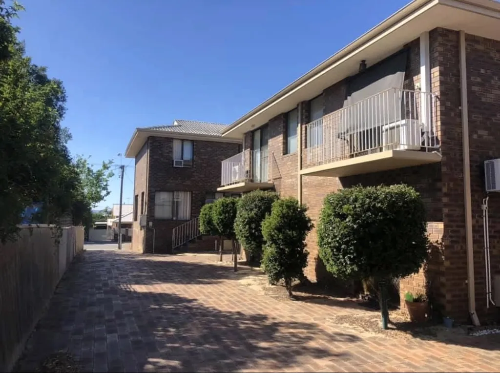 Brick units along a driveway before rendering