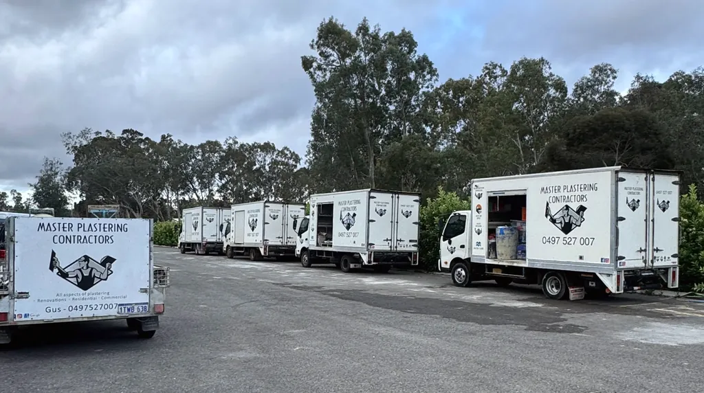 Master Plastering Contractors truck fleet in the yard