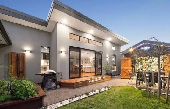 Reference image of a grey rear facade with a timber deck
