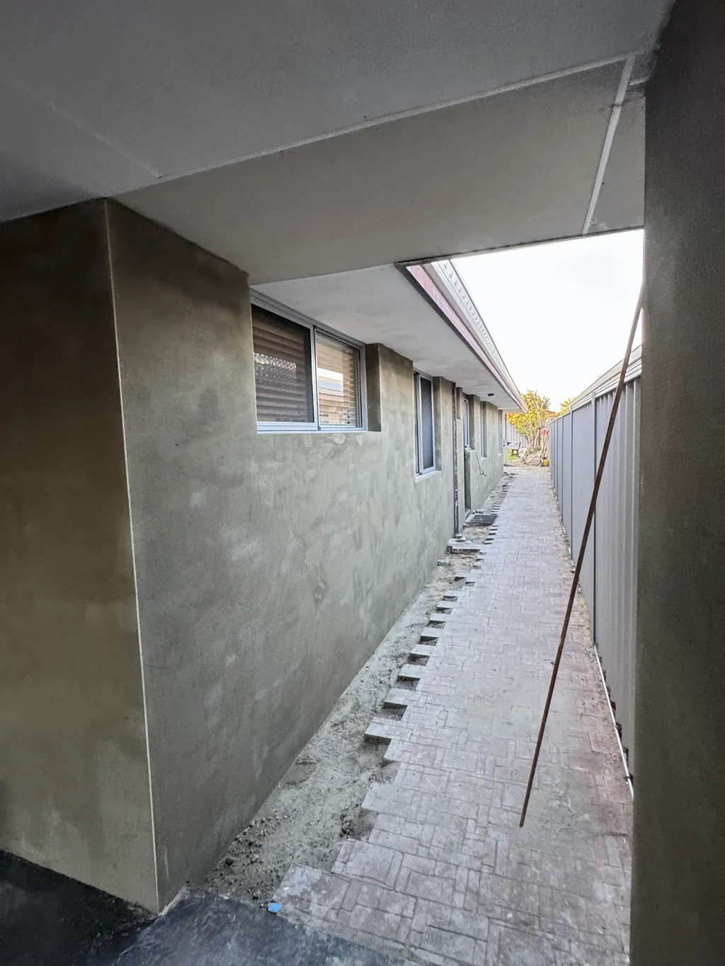 Rendered walls along a narrow side passage