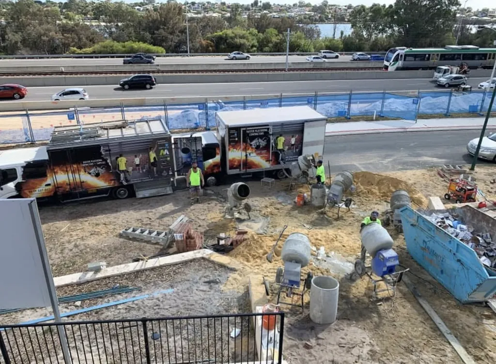 Truck beside a two-storey build under scaffold