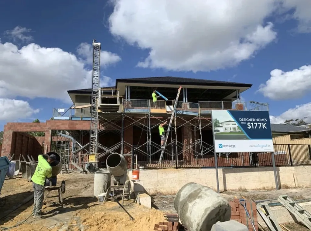 Crew on scaffold of a two-storey build