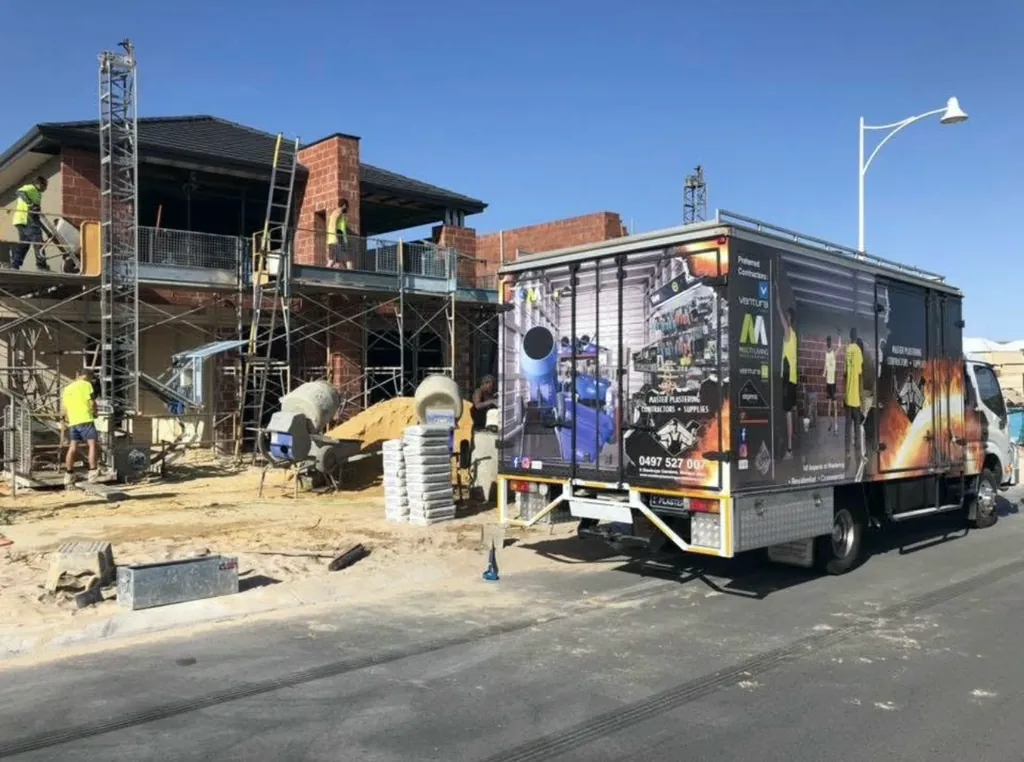 Master Plastering trucks and mixers on a building site